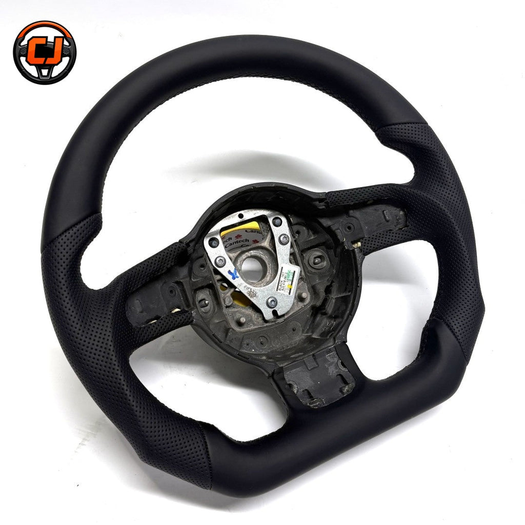 Audi B8 smooth perforated leather steering wheel - angled view showing flat-bottom design and perforated grip sections