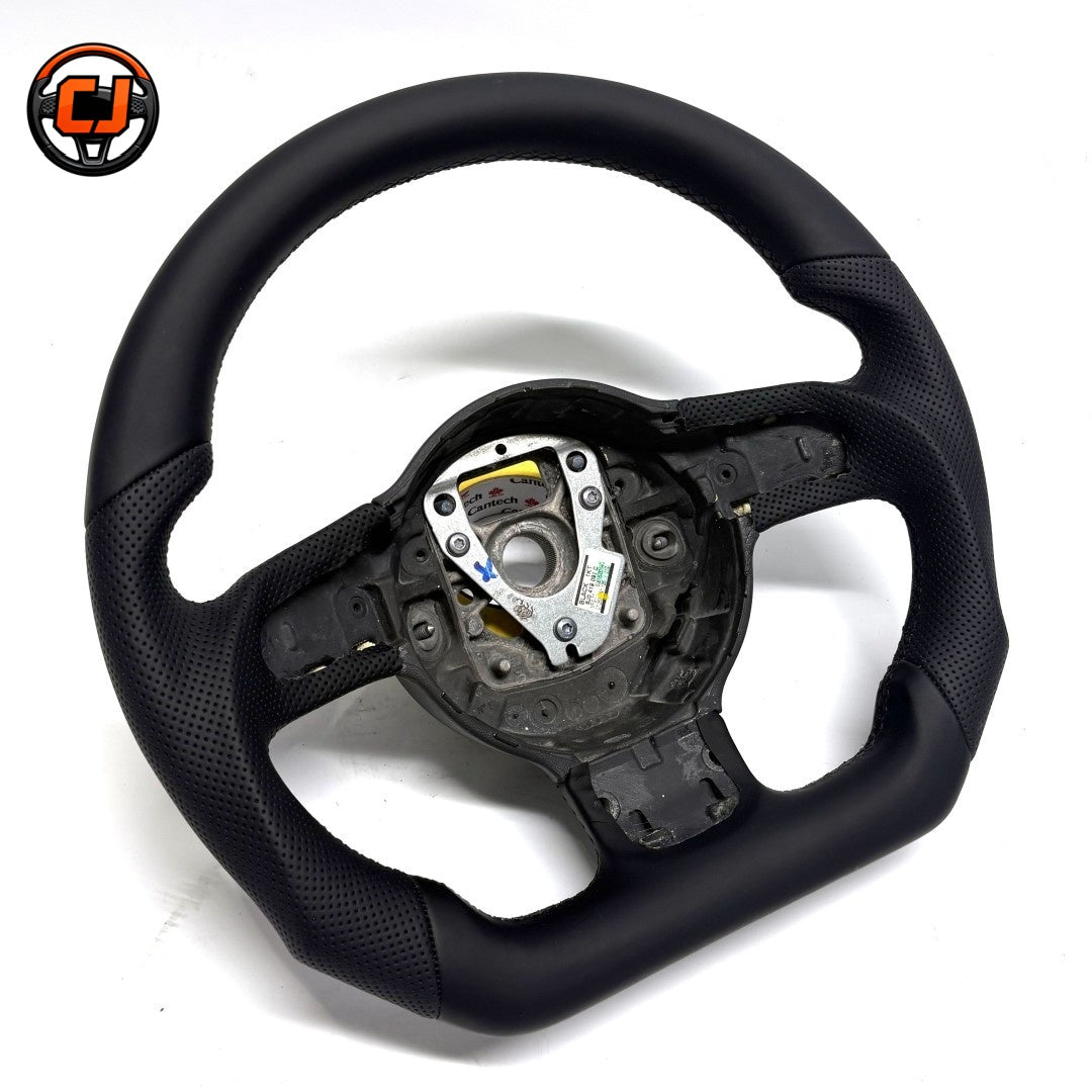 Audi B8 smooth perforated leather steering wheel - angled view showing flat-bottom design and perforated grip sections