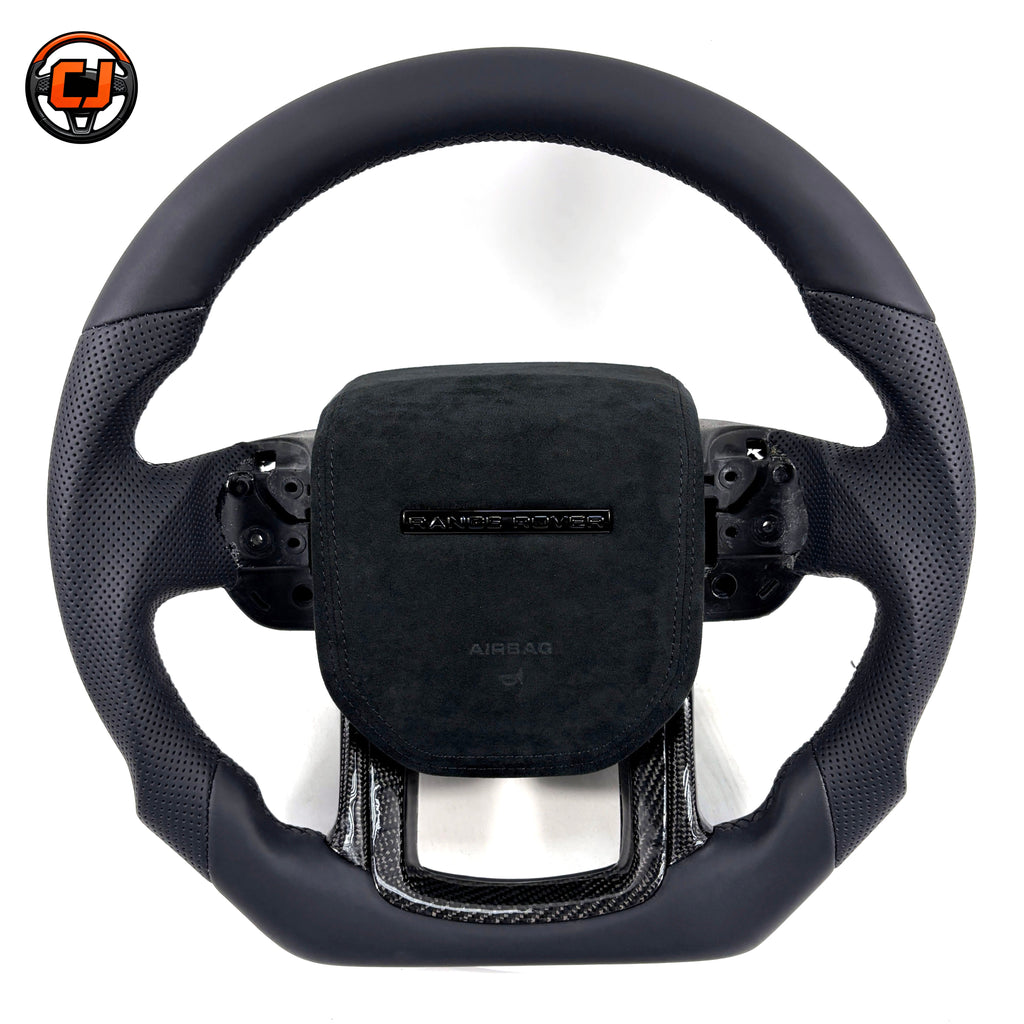 Custom steering wheel for Range Rover Evoque with black smooth leather, perforated leather side grips, Alcantara airbag cover and carbon fiber lower spoke trim