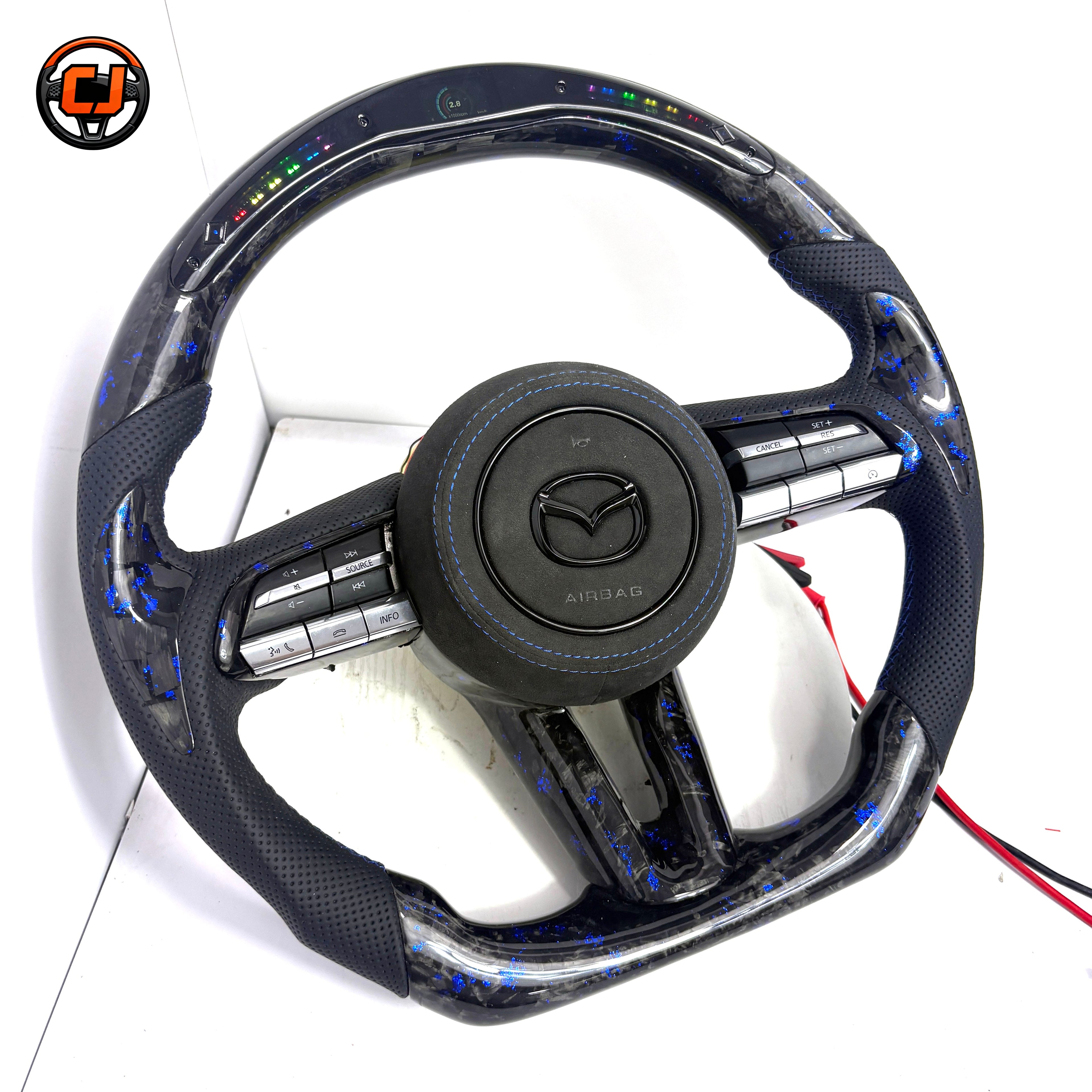 Custom Mazda 3 LED steering wheel with forged carbon blue flakes black perforated leather grips blue stitching and flat bottom design