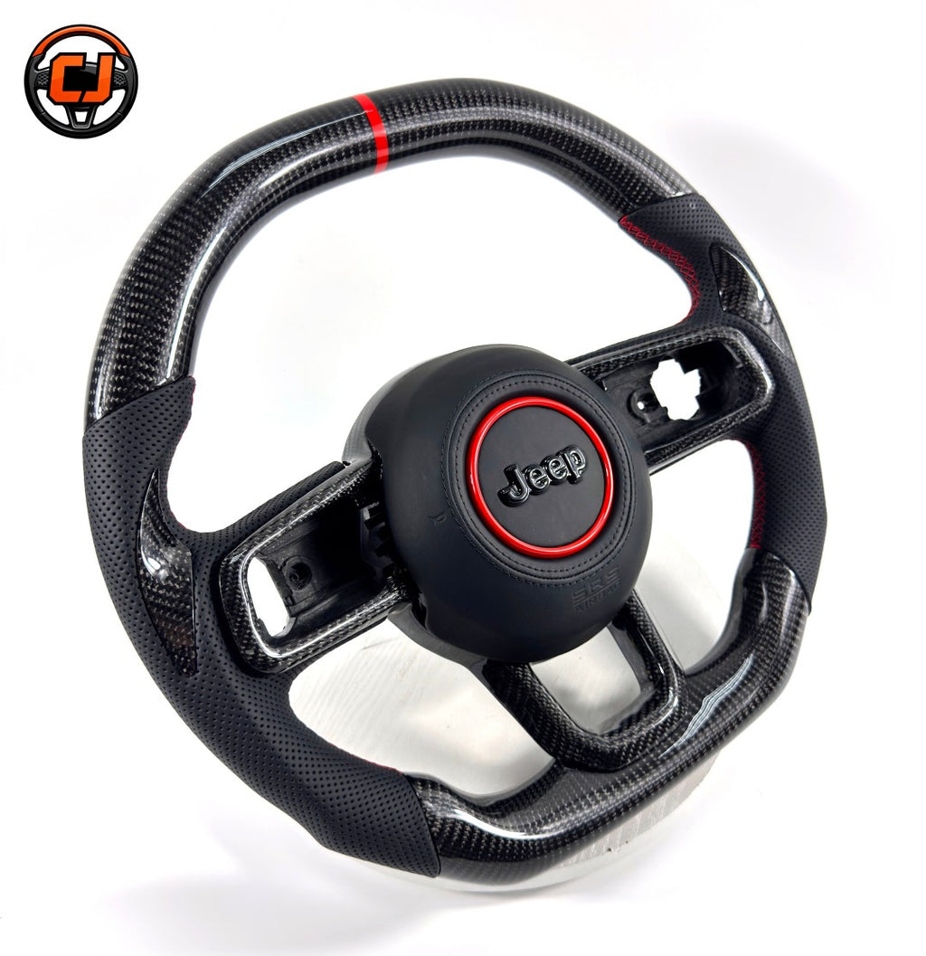 Custom carbon fiber steering wheel for Jeep Wrangler with glossy woven carbon fiber, black perforated leather grips, red 12 o'clock stripe, red stitching and black Jeep airbag cover