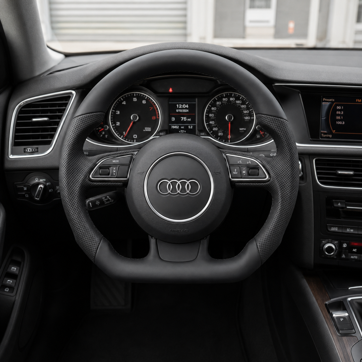 Audi B8 smooth perforated leather steering wheel installed in car interior - driver perspective