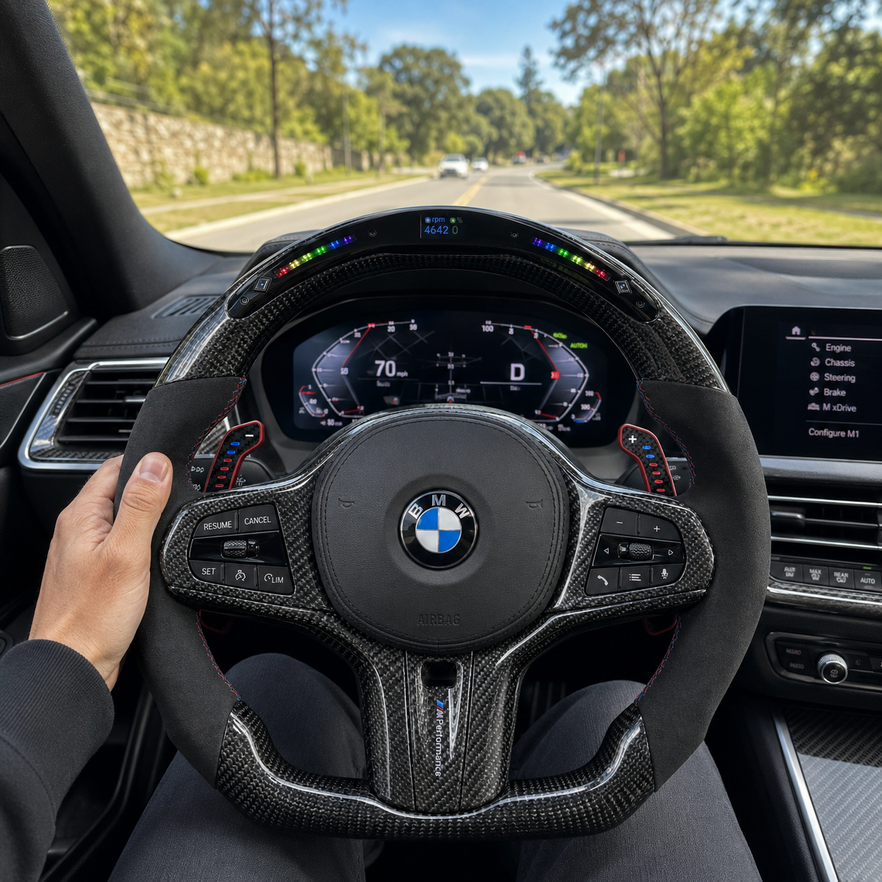BMW G-chassis custom carbon fiber steering wheel with integrated LED RPM display, Alcantara grips, illuminated paddle shifters, and round airbag cover installed in BMW G02 G05 G06 G09 G11 G12 G15 G20 G22 G28 G29 G30 G38 G80 G82 F40 F90 interior driving scene