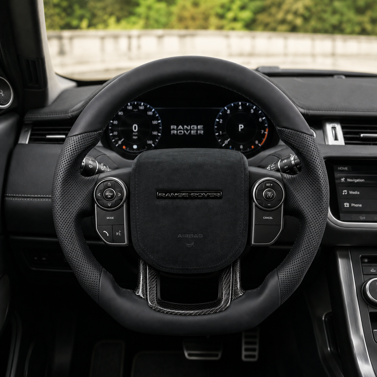 Front interior view of custom Range Rover steering wheel with black leather, perforated side grips, Alcantara airbag cover and carbon fiber lower spoke