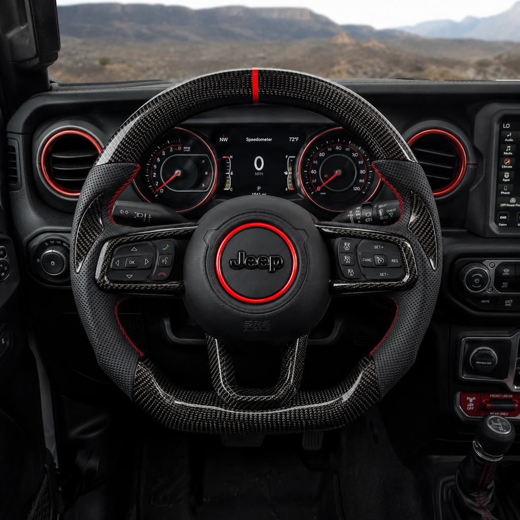 Front interior view of custom Jeep Wrangler carbon fiber steering wheel with glossy carbon fiber rim, black perforated leather grips, red accent ring and red 12 o'clock stripe
