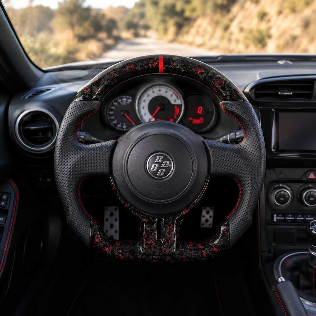 Toyota GT86 forged carbon fiber steering wheel with red flake accents, perforated leather grips and red center stripe installed in cockpit by CJ Mod Garage
