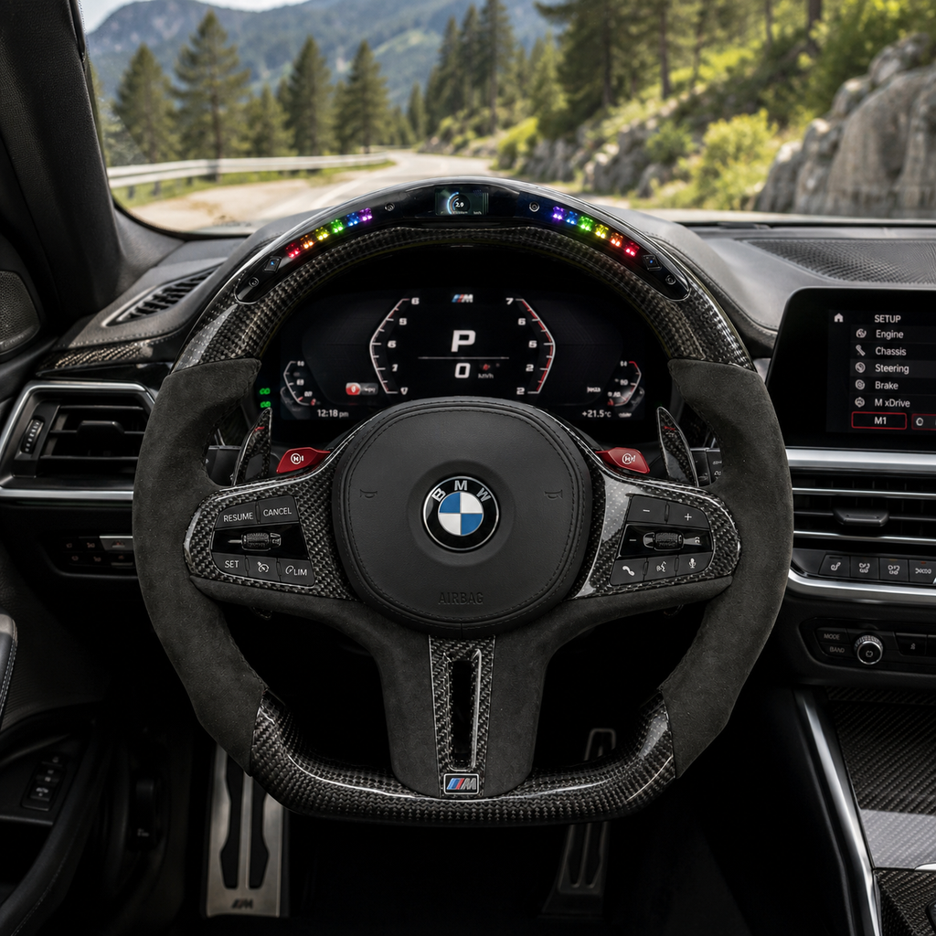 CJ Mod Garage custom BMW LED carbon fiber steering wheel installed in BMW G-chassis interior featuring integrated RGB LED shift lights, digital top display, gloss carbon fiber finish, Alcantara grips, flat-bottom sport design, multifunction controls, and compatibility with BMW G02 G05 G06 G09 G11 G12 G15 G20 G22 G28 G29 G30 G38 G80 G82 F40 F90 models