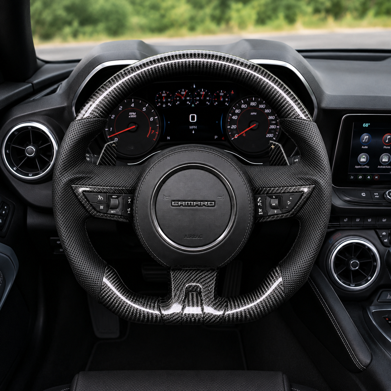 Custom Chevrolet Camaro steering wheel installed in vehicle interior with glossy carbon fiber finish black perforated leather grips and sport flat bottom design