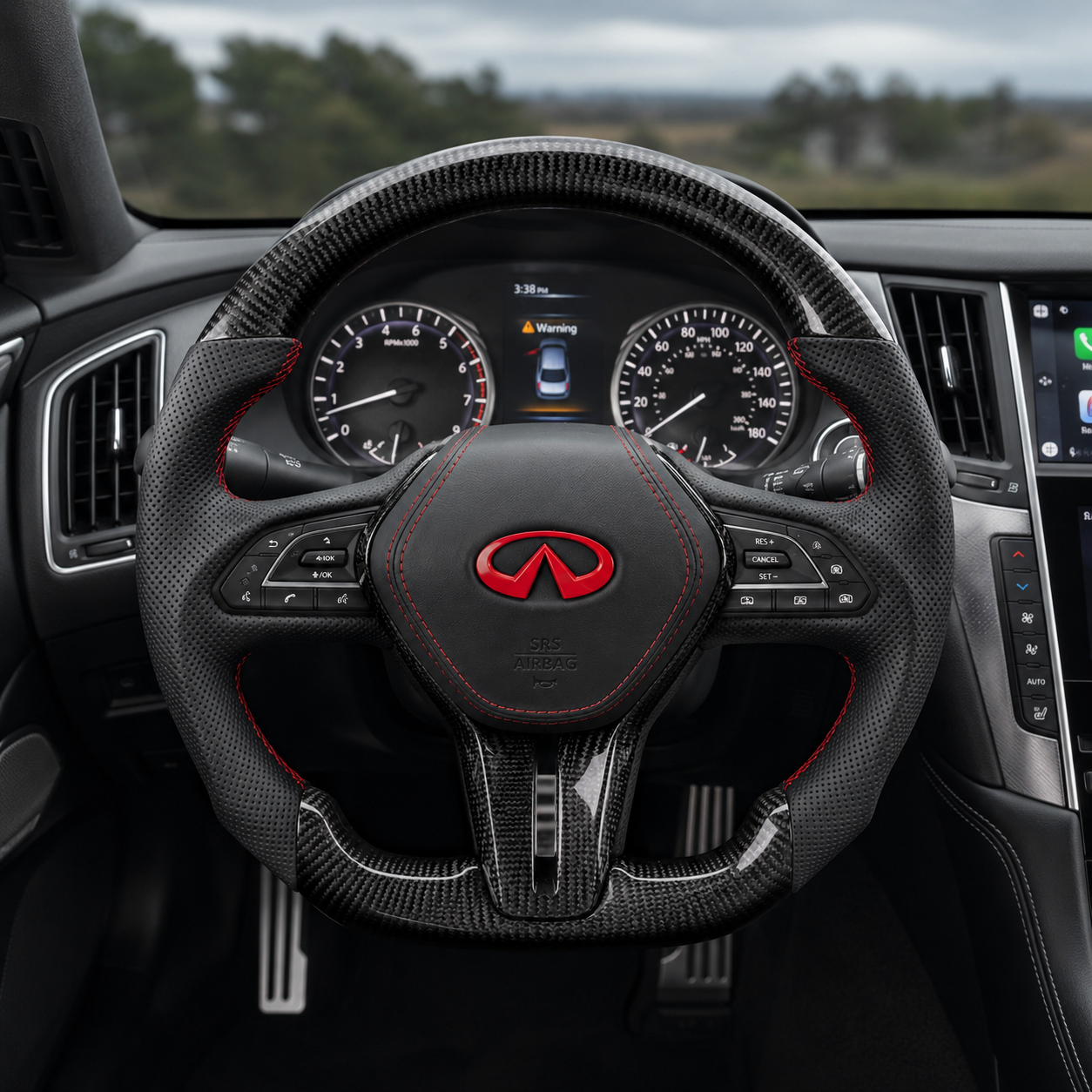 Infiniti Q60 custom carbon fiber steering wheel installed in vehicle interior with perforated leather grips red stitching and red Infiniti emblem by CJ Mod Garage