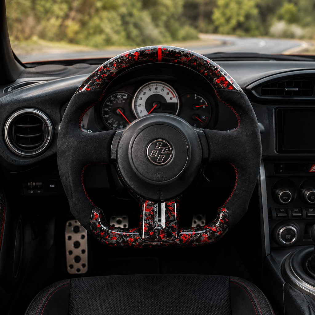 Toyota GT86 forged carbon steering wheel with red carbon flakes, Alcantara grips, red center stripe and flat-bottom performance design installed in cabin by CJ Mod Garage