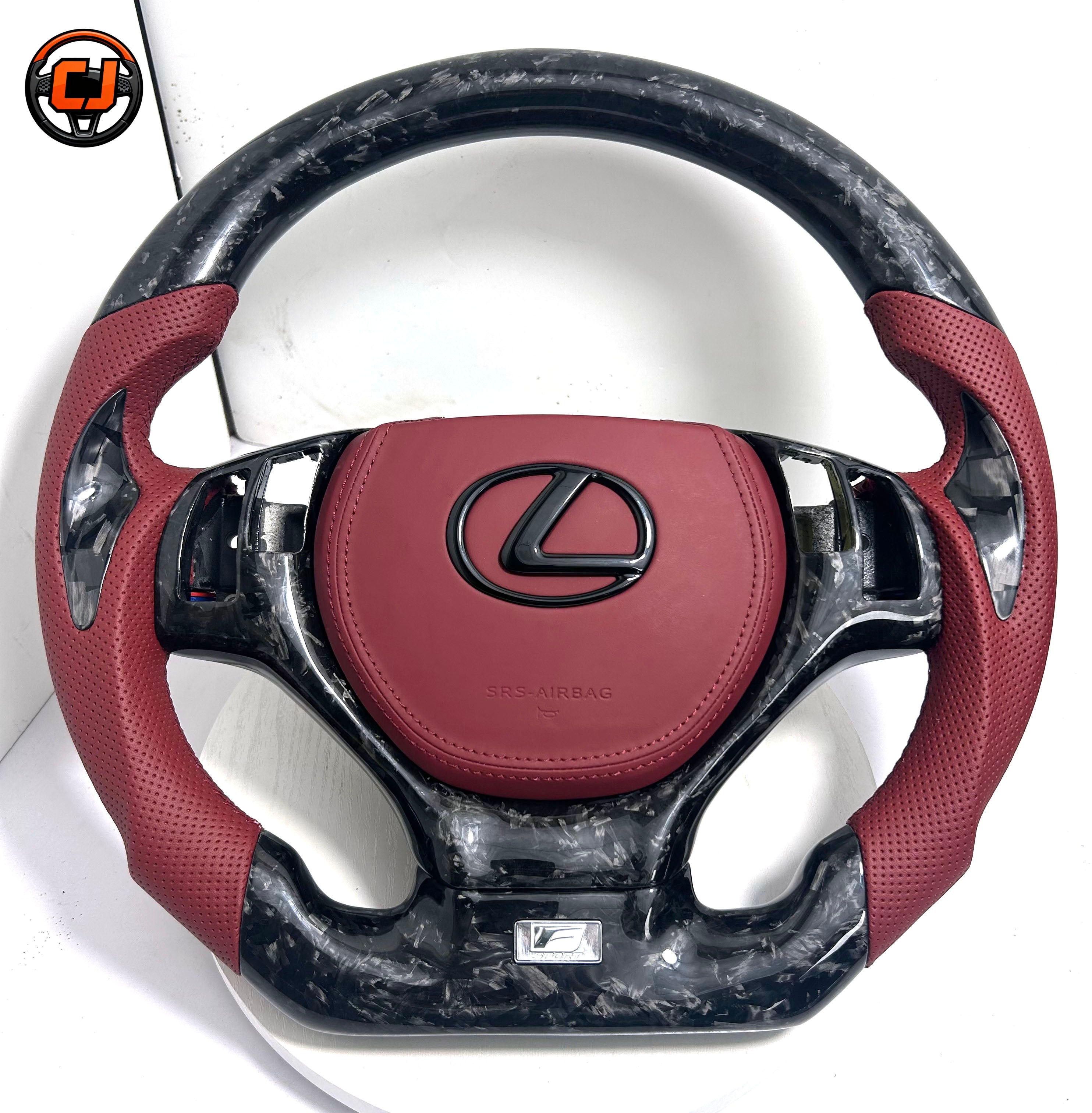 Close up product image of custom Lexus GS carbon fiber steering wheel with red leather airbag cover and red perforated leather side grips