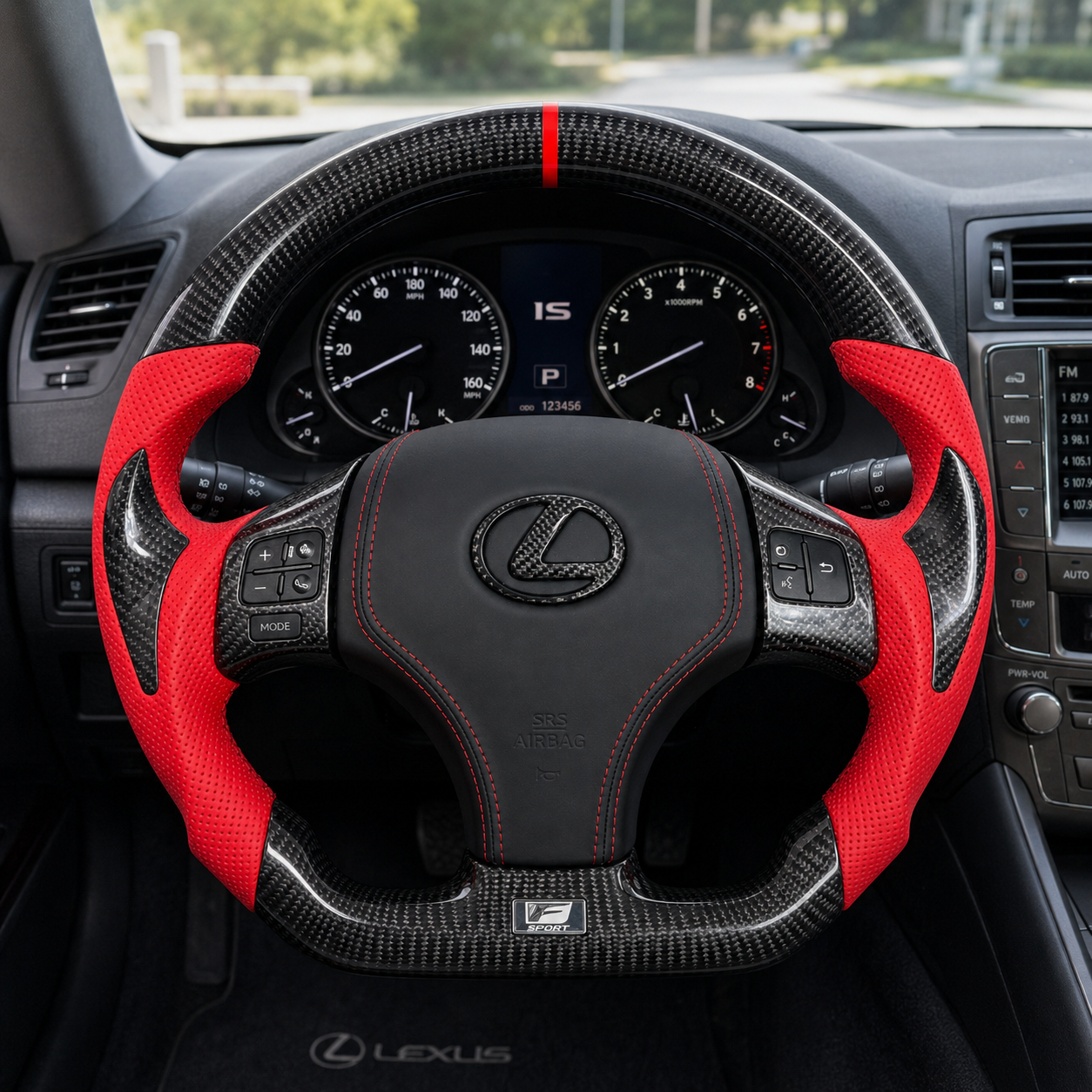 Front interior view of custom Lexus IS series carbon fiber steering wheel with red perforated leather side grips, red center stripe, black airbag cover and red stitching
