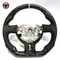 Custom Toyota GT86 steering wheel crafted from forged carbon fiber and premium perforated leather, showcasing white 12 o’clock stripe and ergonomic sport grip design by CJ Mod Garage