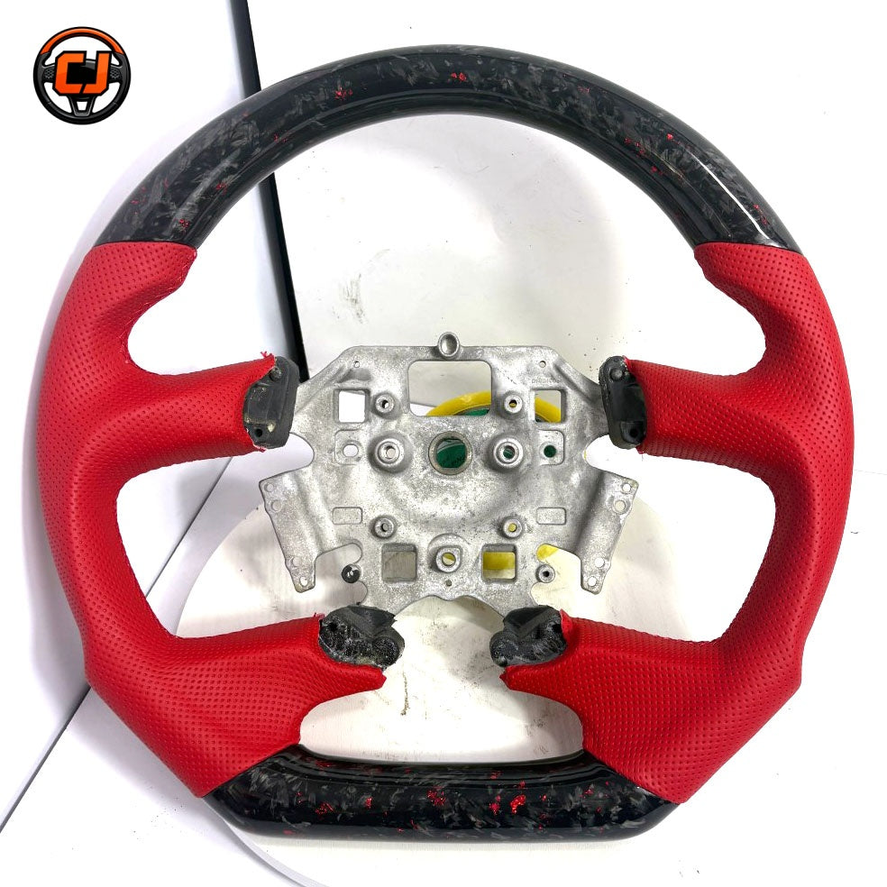 Front view of Ford Falcon FG XR XR6 XR8 custom steering wheel with red flake forged carbon and red perforated leather by CJ Mod Garage