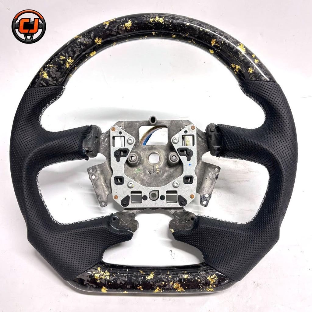 Front view of Ford Falcon FG XR XR6 XR8 custom steering wheel with gold flake forged carbon and black perforated leather by CJ Mod Garage