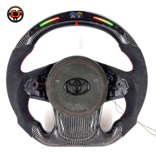 Toyota GR Supra A90 A91 performance steering wheel built with carbon fiber construction, LED RPM indicator, Alcantara grip sections and red center marker by CJ Mod Garage