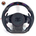 Custom Toyota GR Supra A90 A91 steering wheel crafted with premium carbon fiber, Alcantara wrapping, integrated LED shift lights, red center stripe and paddle shifters by CJ Mod Garage