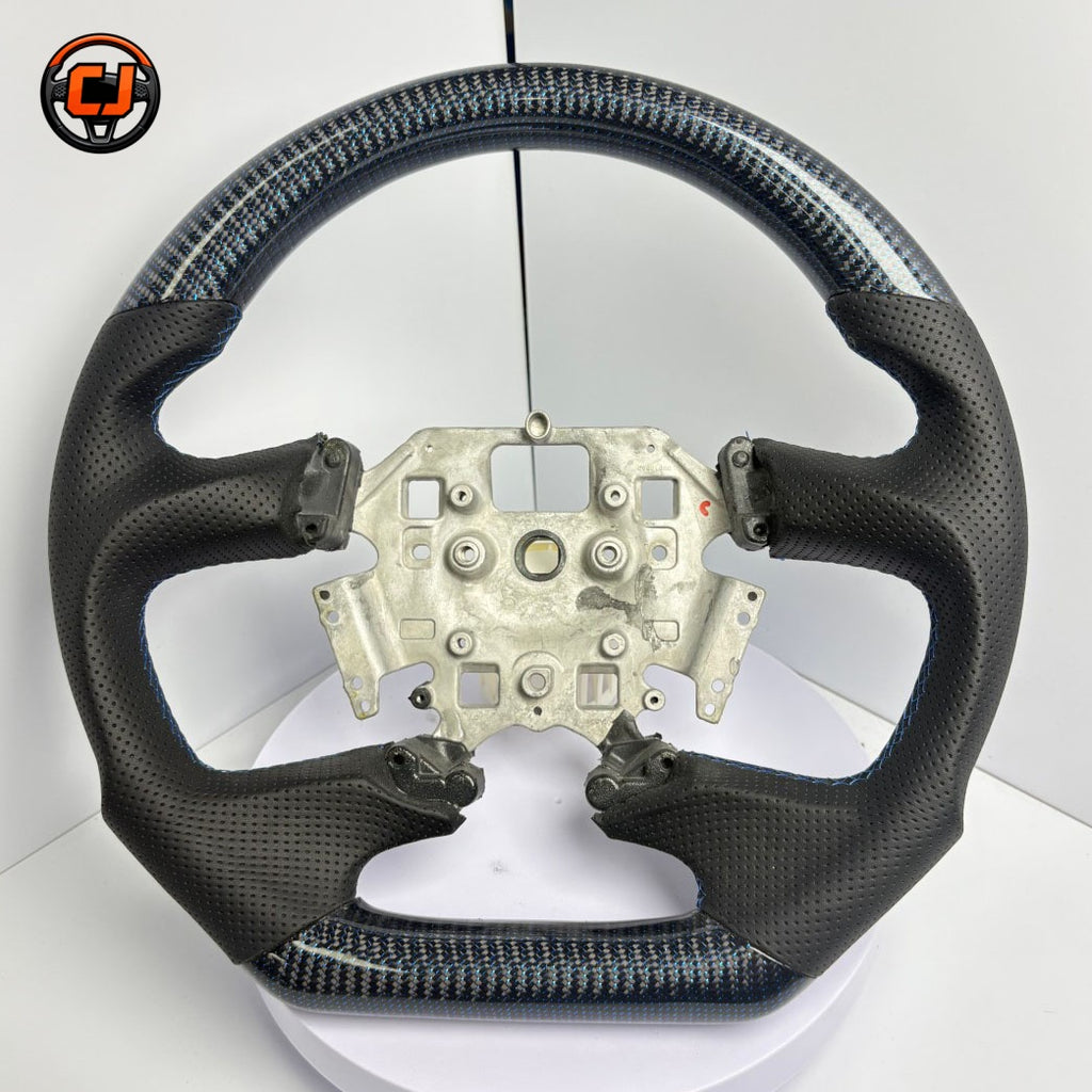 Front view of Ford Falcon FG XR XR6 XR8 custom steering wheel with blue carbon fiber black perforated leather and blue stitching by CJ Mod Garage