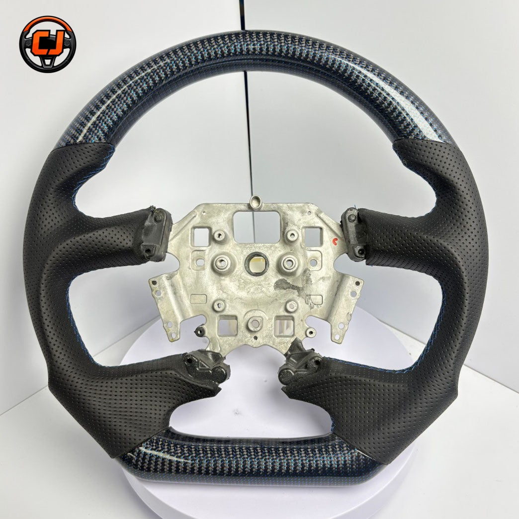 Front view of Ford Falcon FG XR XR6 XR8 custom steering wheel with blue carbon fiber black perforated leather and blue stitching by CJ Mod Garage