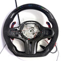 BMW G-series custom carbon fiber steering wheel frame with LED display, Alcantara side grips, illuminated paddle shifters, and round airbag mounting layout for BMW G02 G05 G06 G09 G11 G12 G15 G20 G22 G28 G29 G30 G38 G80 G82 F40 F90