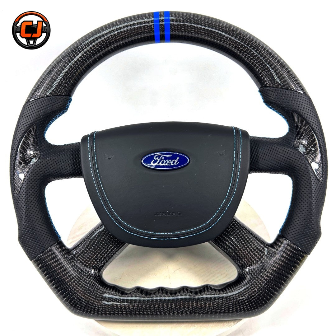 Custom Ford Focus Mk3 Mk3.5 steering wheel crafted from real carbon fiber with perforated leather grip zones, blue accent stripe and performance-inspired styling by CJ Mod Garage