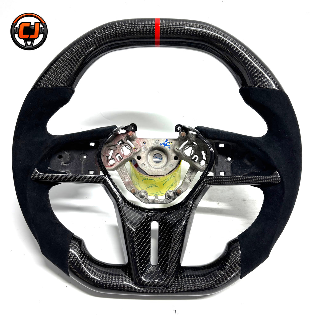 Nissan GT R R35 performance steering wheel featuring glossy carbon fiber Alcantara side grips flat bottom design and motorsport inspired styling by CJ Mod Garage