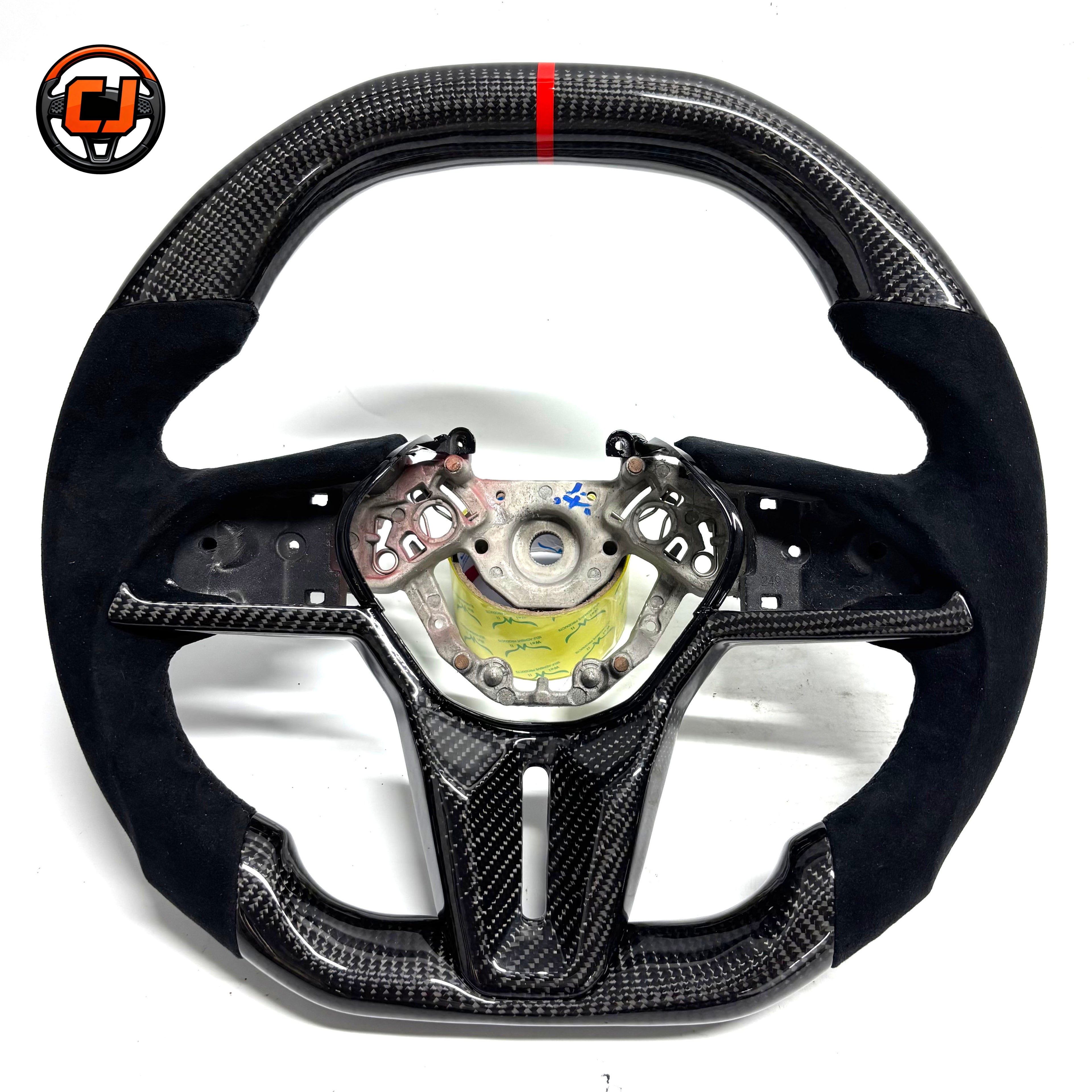 Nissan GT R R35 performance steering wheel featuring glossy carbon fiber Alcantara side grips flat bottom design and motorsport inspired styling by CJ Mod Garage