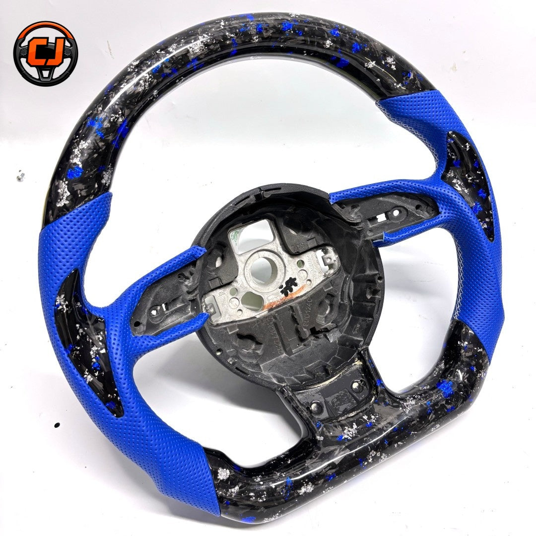 Audi B8 forged carbon blue perforated leather steering wheel - angled product shot showing blue and silver flake pattern