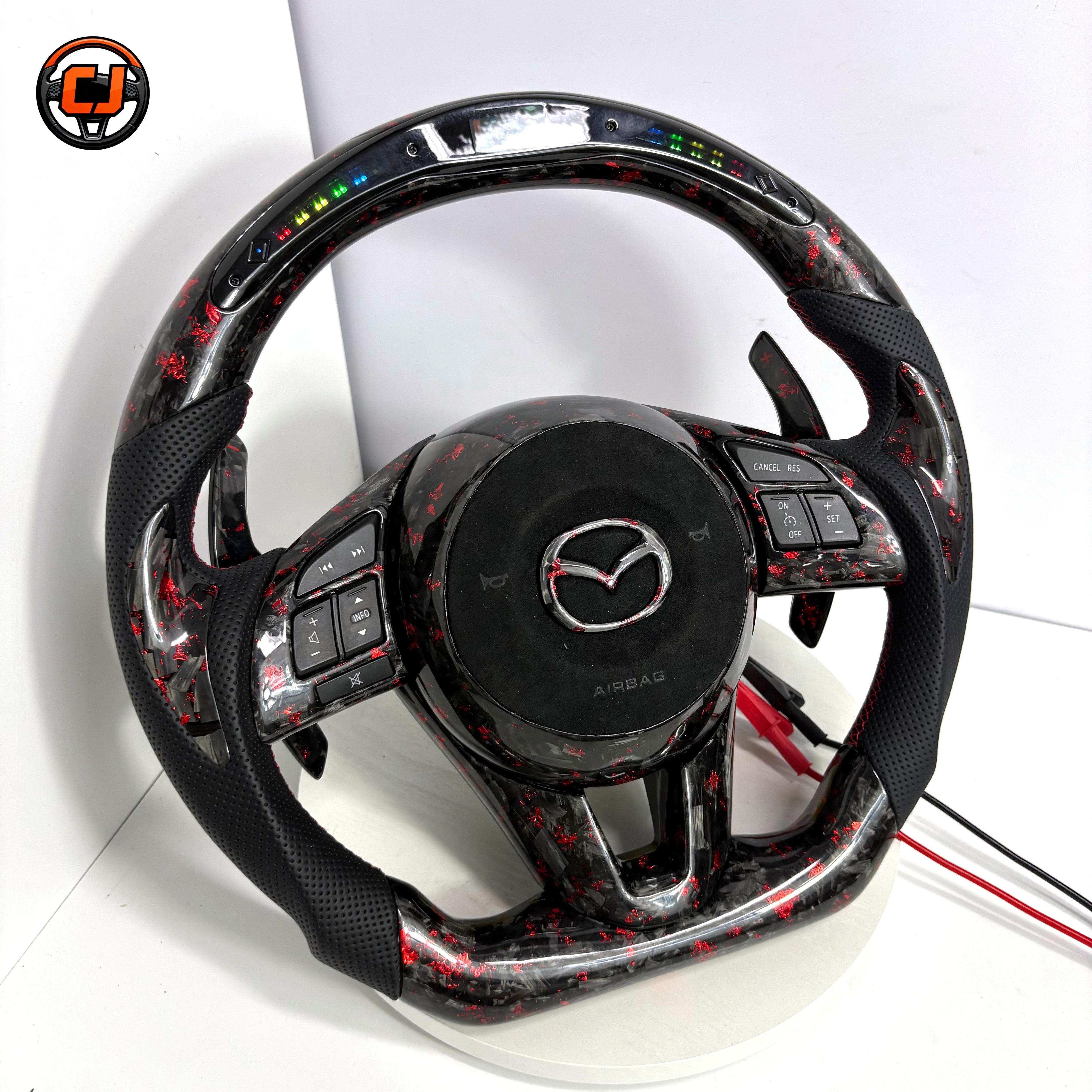 Custom Mazda 3 Axela LED steering wheel with forged carbon red flakes black perforated leather grips red stitching paddle shifters and flat bottom design