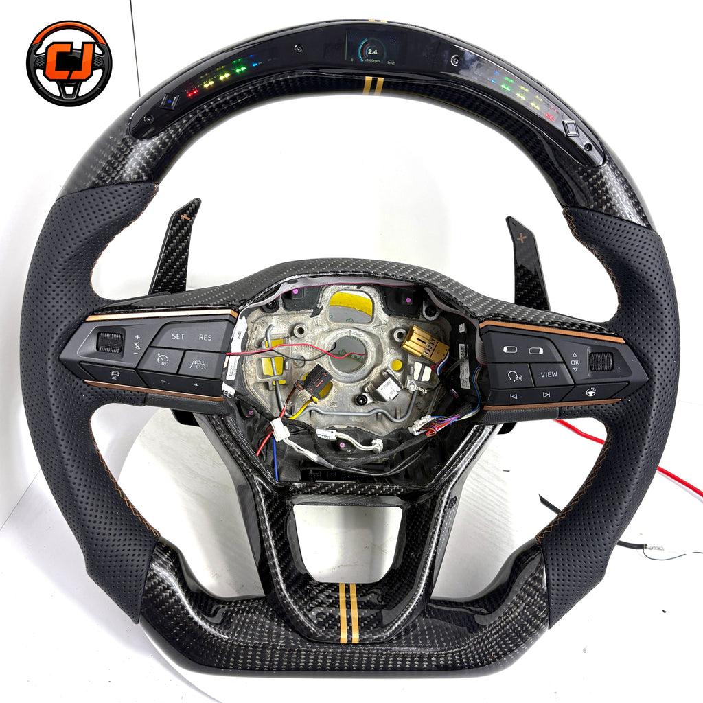 Handcrafted Seat Leon MK4 carbon fiber steering wheel with integrated buttons paddle shifters perforated leather grip and performance inspired styling by CJ Mod Garage