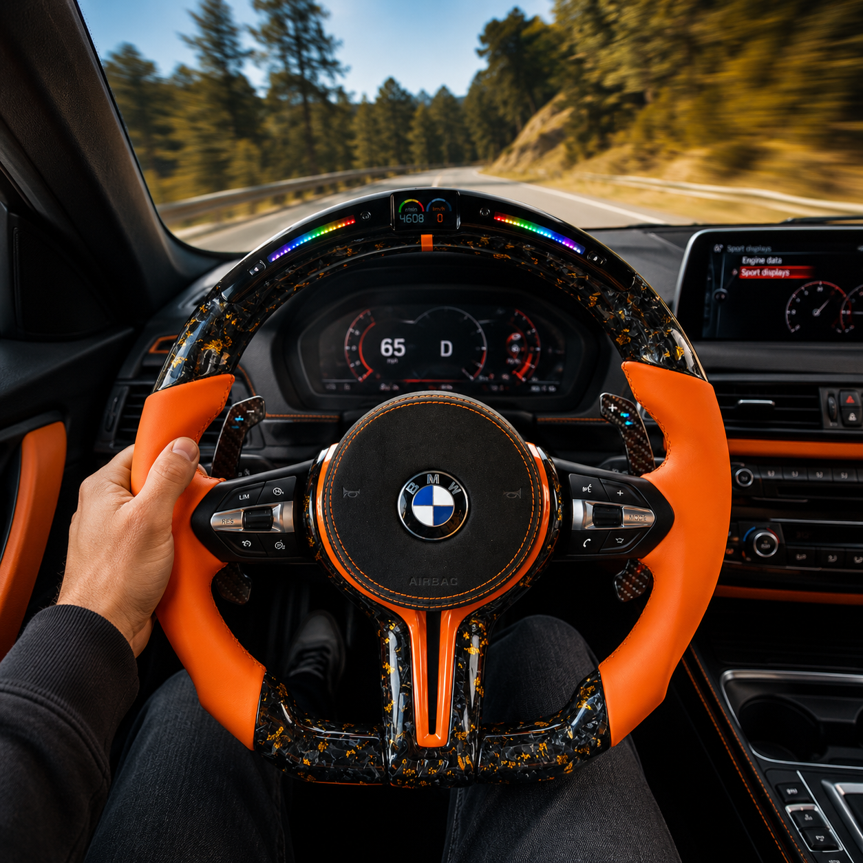 Custom BMW forged carbon fiber steering wheel with gold flakes, orange leather side grips, RGB LED shift light display, and carbon paddle shifters installed in BMW F10 F11 F15 F18 F20 F23 F25 F30 F32 F35 F40 F80 E84 E87 E90 E92 E93 interior