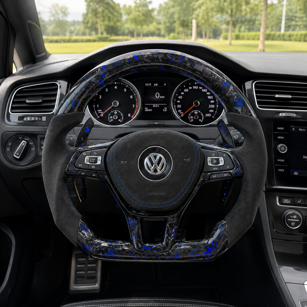 Blue forged carbon steering wheel installed in vehicle interior with Alcantara grips and paddle shifters for Golf 7 MK7 Passat Touareg Tiguan Polo GTD MK6 R Line CC Jetta by CJ Mod Garage
