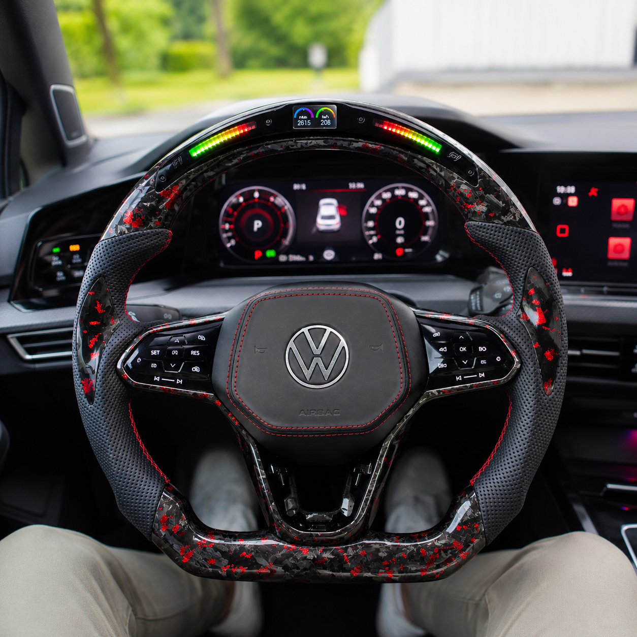 Forged carbon steering wheel with red flake accents LED shift indicator and perforated leather grips mounted in vehicle interior for Golf 8 MK8 Passat Touareg Tiguan Polo GTD MK7 MK6 R Line CC Jetta by CJ Mod Garage