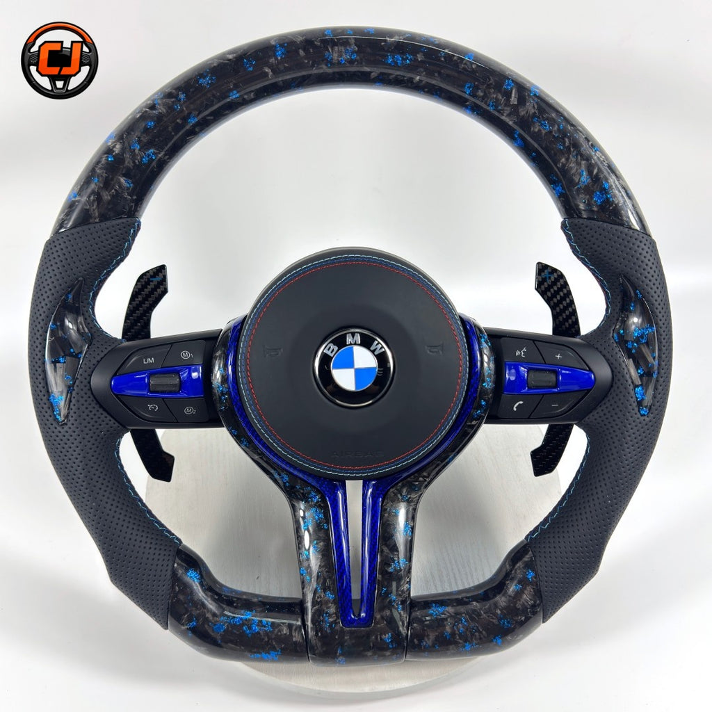 BMW forged carbon steering wheel with blue marble carbon finish, blue center accent, black perforated leather grips, carbon paddle shifters, and round airbag cover for BMW F10 F11 F15 F18 F20 F23 F25 F30 F32 F35 F40 F80 E84 E87 E90 E92 E93