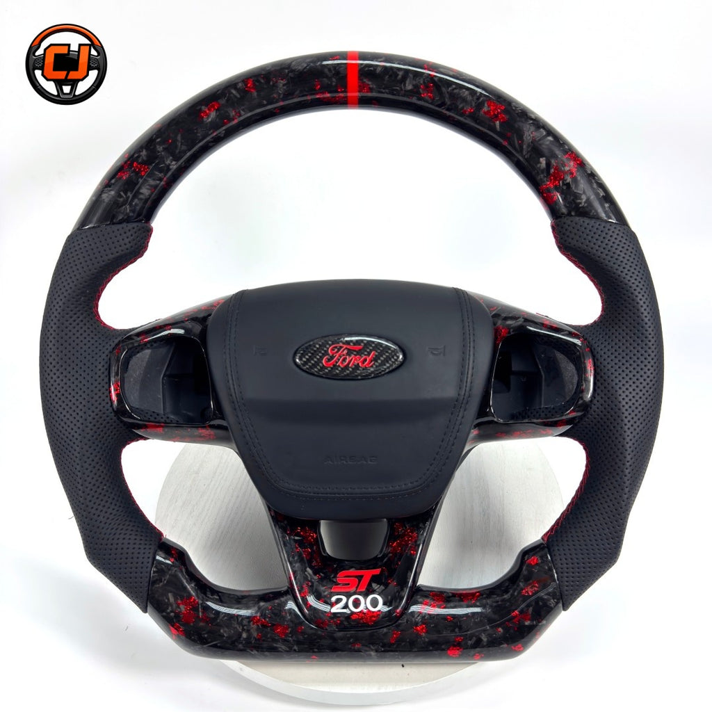 Custom Ford Focus RS ST forged carbon steering wheel with red forged carbon accents, ergonomic leather grip areas, ST200 lower trim and premium handcrafted finish by CJ Mod Garage