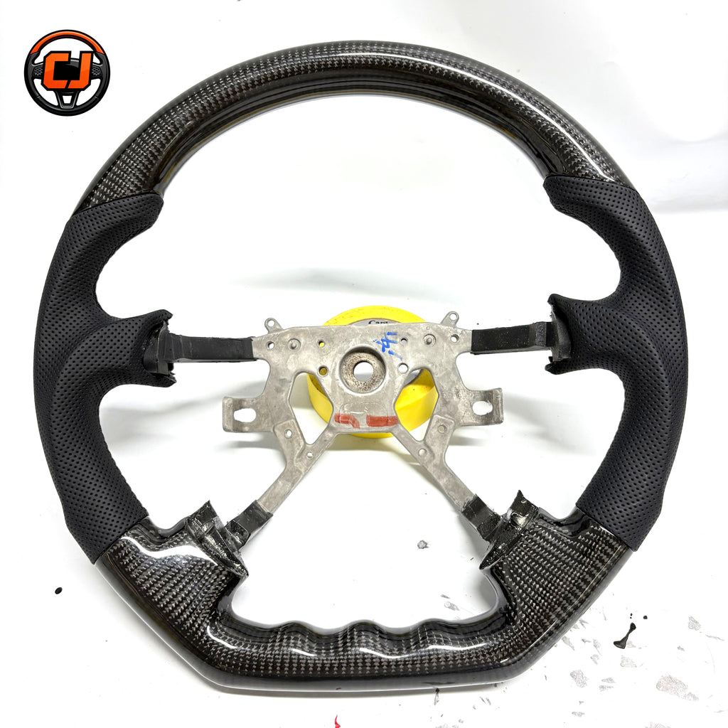Nissan Patrol Y61 Safari glossy carbon fiber steering wheel detail with ergonomic grip design by CJ Mod Garage