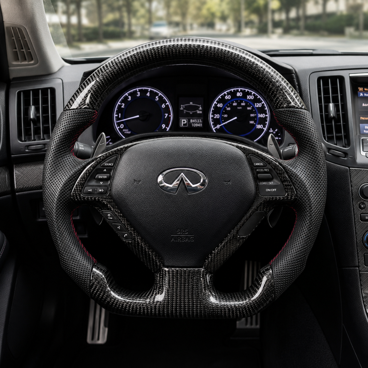 Infiniti G25 G37 custom carbon fiber steering wheel installed in cockpit with perforated leather grips red stitching and paddle shifters by CJ Mod Garage