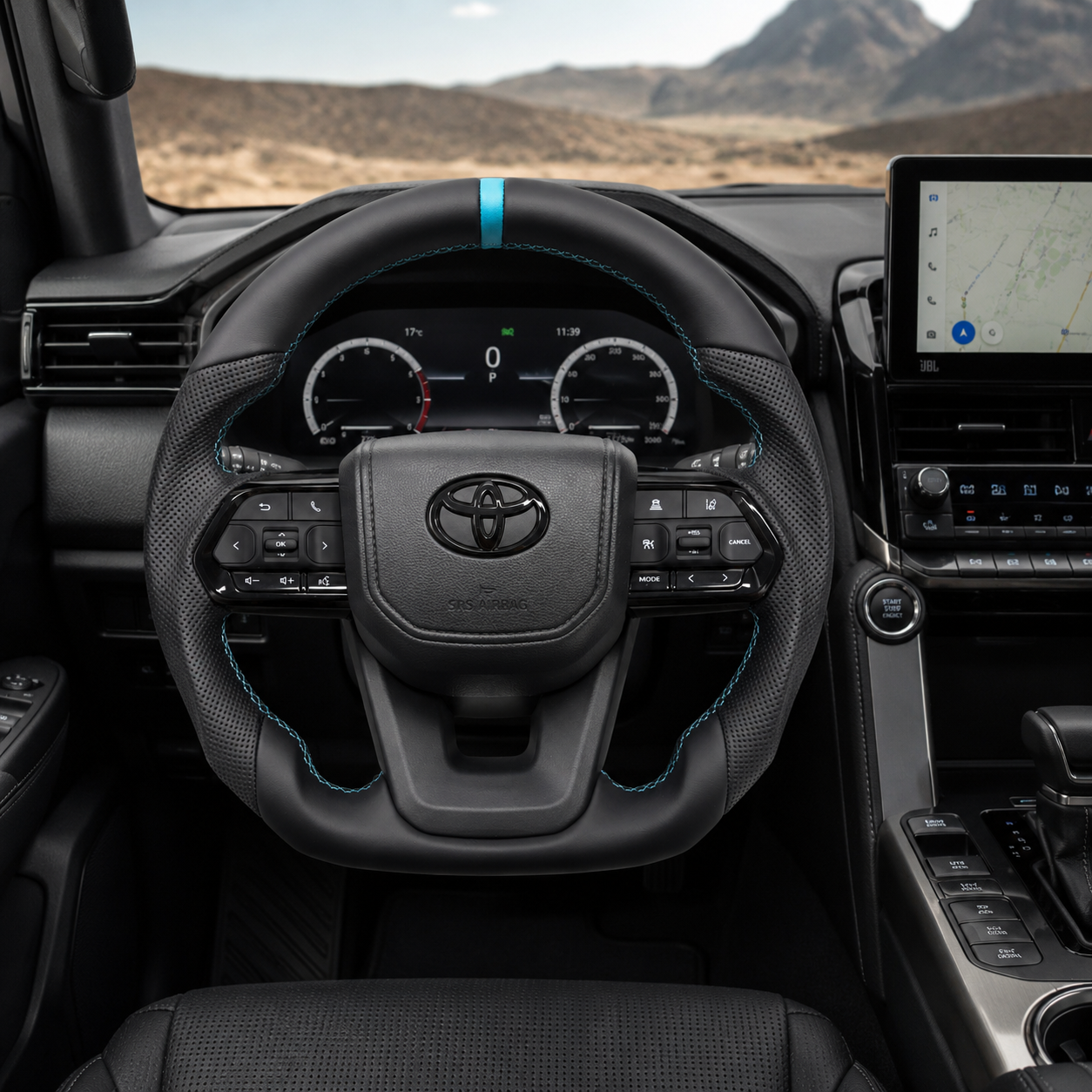 Toyota Land Cruiser LC300 custom leather steering wheel with perforated leather side grips, light blue center stripe and matching stitching installed in vehicle interior by CJ Mod Garage
