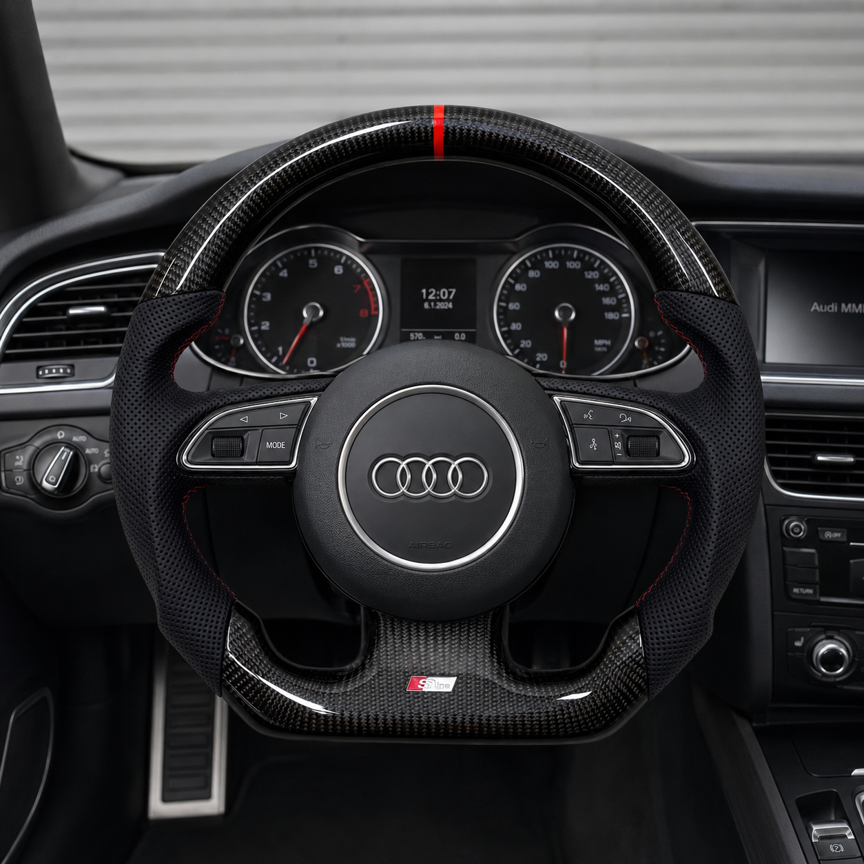 Audi B8 gloss carbon fiber steering wheel installed in Audi A4 interior - front-on view showing red stripe and S-line badge