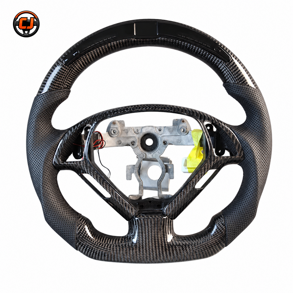 Custom Infiniti G37 carbon fiber steering wheel frame featuring flat bottom design perforated leather grips and OEM control openings by CJ Mod Garage