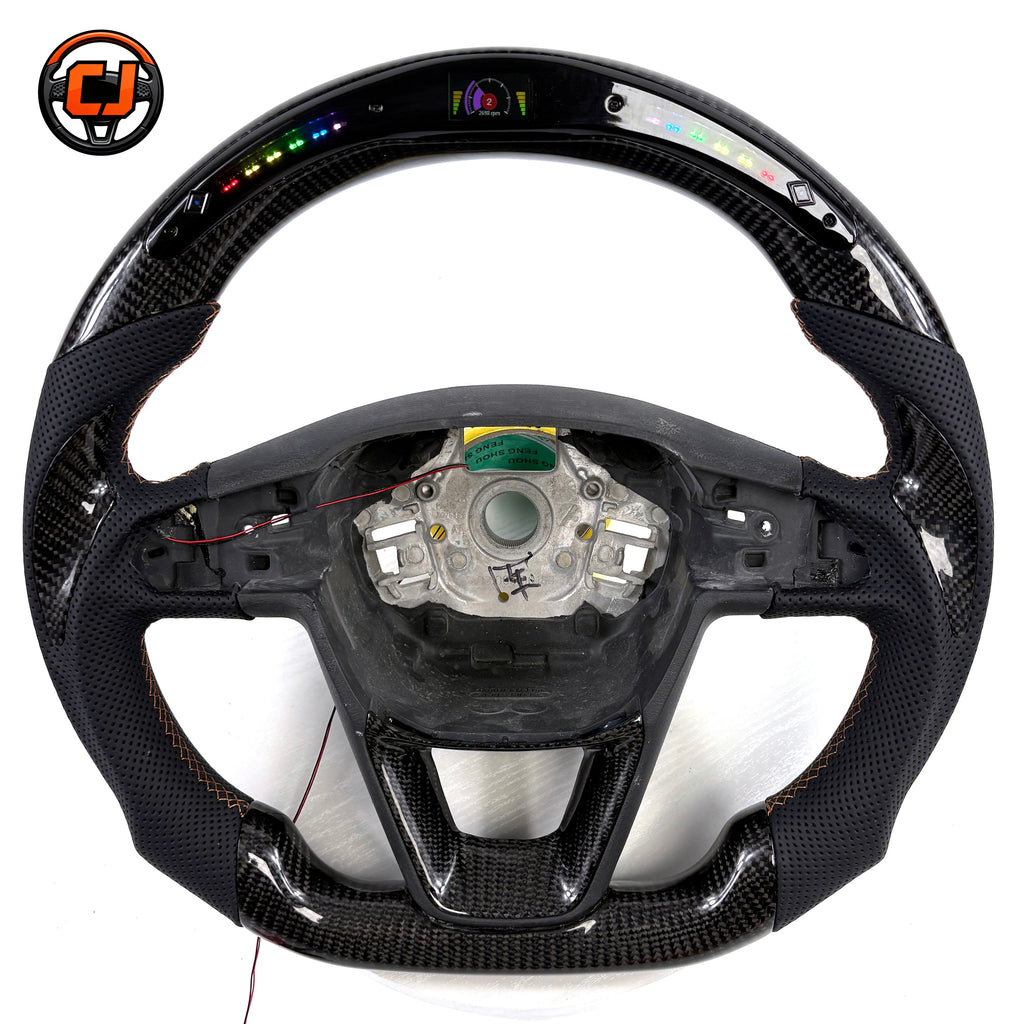 Handcrafted Seat Leon MK4 carbon fiber steering wheel with integrated buttons paddle shifters perforated leather grip and performance inspired styling by CJ Mod Garage