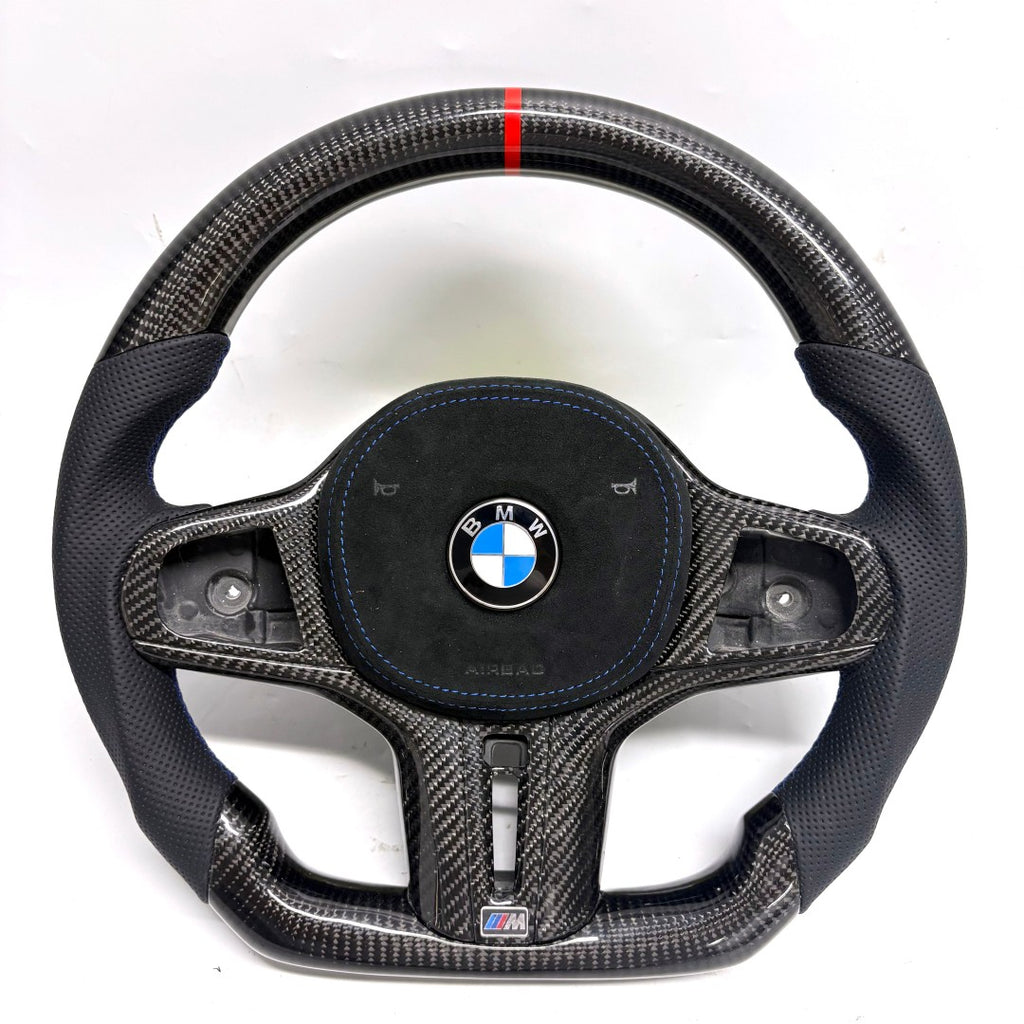 BMW G-chassis carbon fiber steering wheel on white background featuring perforated leather grips, blue stitching, flat-bottom performance contour, and red top center marker for BMW G02 G05 G06 G09 G11 G12 G15 G20 G22 G28 G29 G30 G38 G80 G82 F40 F90