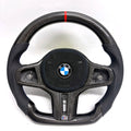 BMW G-chassis carbon fiber steering wheel on white background featuring perforated leather grips, blue stitching, flat-bottom performance contour, and red top center marker for BMW G02 G05 G06 G09 G11 G12 G15 G20 G22 G28 G29 G30 G38 G80 G82 F40 F90