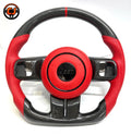Studio front view of custom Jeep Wrangler carbon fiber steering wheel with red perforated leather grips, red leather airbag cover, red 12 o'clock stripe and flat bottom sport design