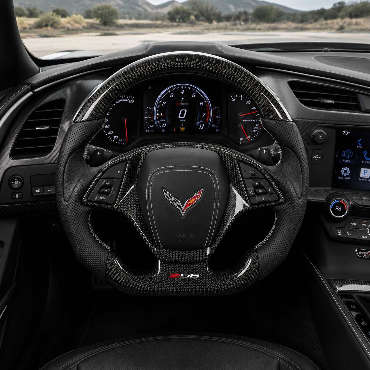 Chevrolet Corvette C7 custom steering wheel cockpit front view with glossy carbon fiber finish perforated leather grips and Z06 lower badge