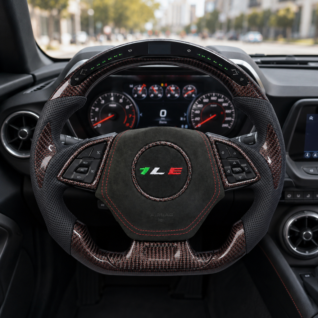 Front interior view of custom Chevrolet Camaro steering wheel with led display forged carbon trim perforated leather grips suede center and one le emblem