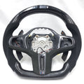 BMW G-chassis carbon fiber LED steering wheel frame on white background with Alcantara side grips, carbon paddle shifters, integrated LED display, and flat-bottom motorsport styling for BMW G02 G05 G06 G09 G11 G12 G15 G20 G22 G28 G29 G30 G38 G80 G82 F40 F90 by CJ Mod Garage