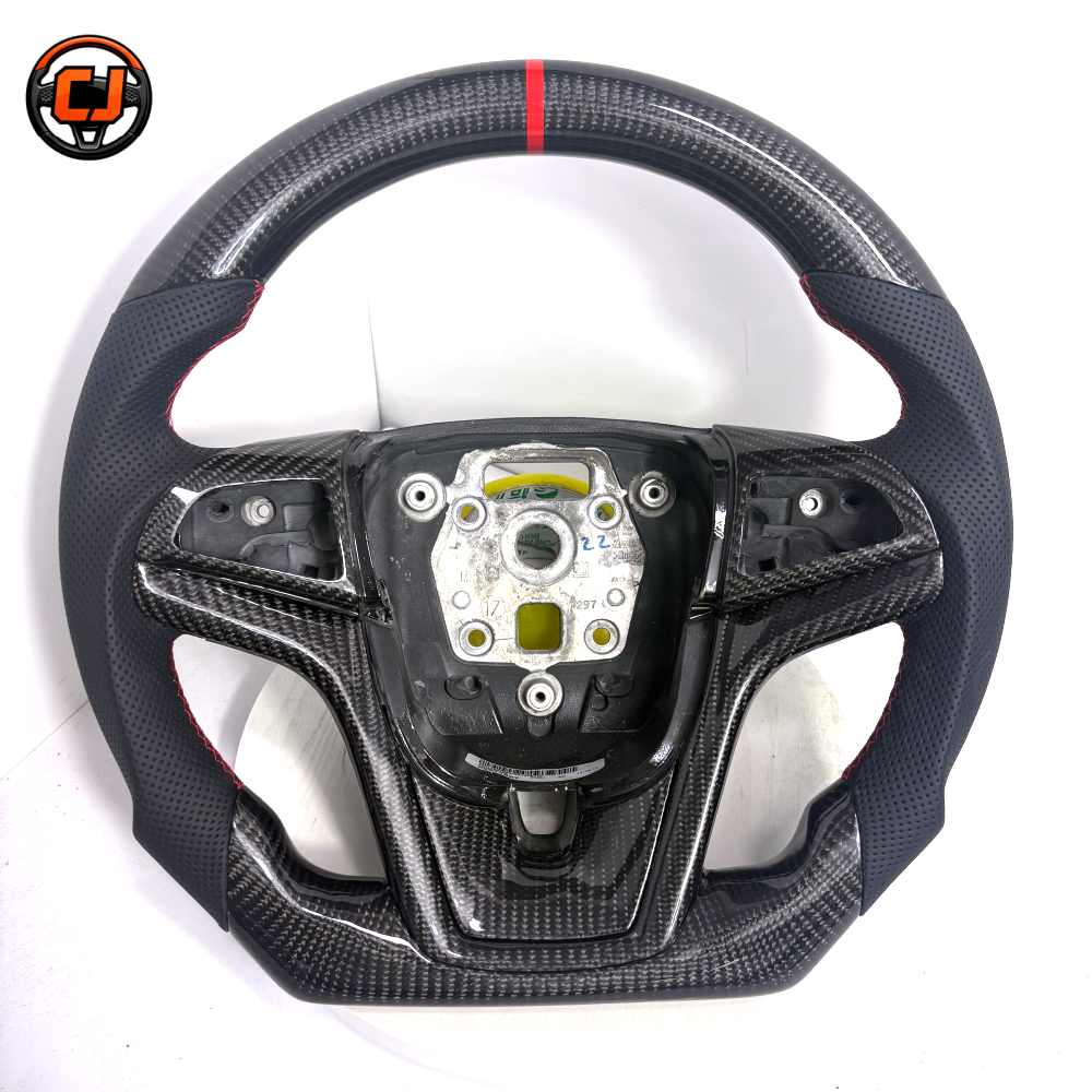 Studio front view of custom Chevrolet Camaro carbon fiber steering wheel with black perforated leather grips red stitching red center stripe flat bottom design and exposed center mounting structure