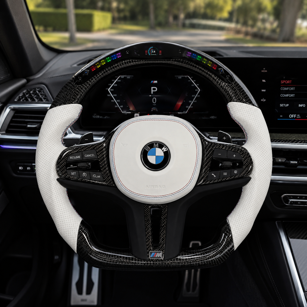 CJ Mod Garage BMW G-chassis custom LED carbon fiber steering wheel installed in BMW interior featuring gloss carbon fiber frame, integrated LED shift light display, white perforated leather grips, white airbag cover with M stitching, flat-bottom M Performance design, and sporty OEM+ styling compatible with BMW G02 G05 G06 G09 G11 G12 G15 G20 G22 G28 G29 G30 G38 G80 G82 F40 F90