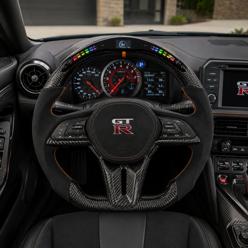 Nissan GT R R35 custom carbon fiber steering wheel with LED shift lights Alcantara grips digital display and orange stitching by CJ Mod Garage